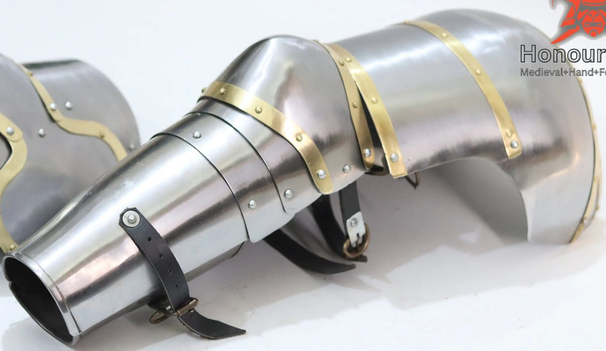 A pair of silver-colored steel arms armor with brass brim and black details, displayed on a white background with a logo and copyright notice.